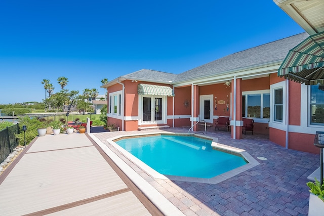 view of pool featuring a patio, fence, french doors, and a fenced in pool