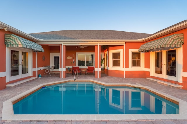 outdoor pool featuring french doors and a patio area