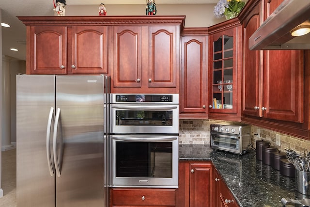 kitchen featuring backsplash, appliances with stainless steel finishes, under cabinet range hood, and dark brown cabinets