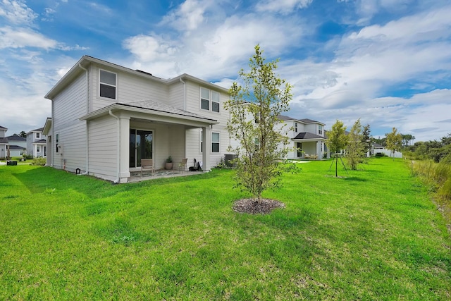 back of property featuring a patio and a lawn