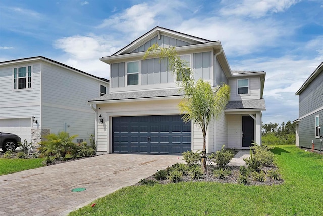 view of front of house with a garage and a front lawn