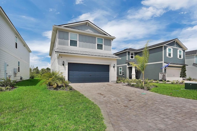 view of front facade with a garage and a front lawn