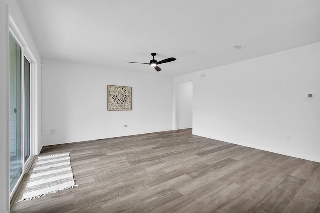 unfurnished room with ceiling fan and light hardwood / wood-style flooring