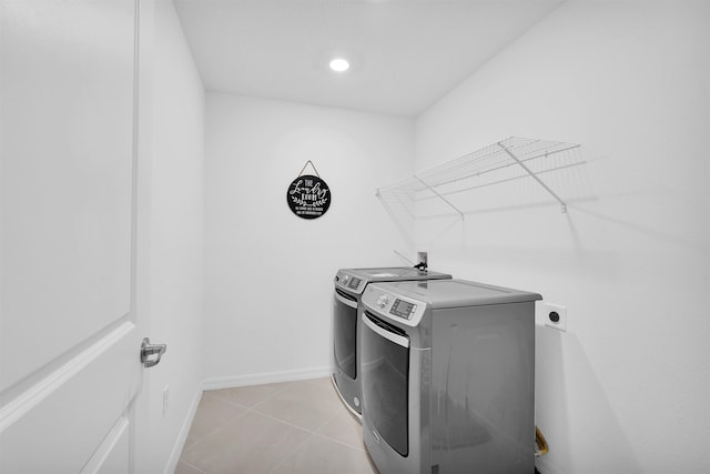 washroom with independent washer and dryer and light tile patterned floors