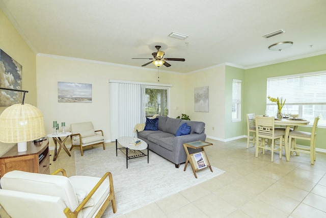 living room featuring crown molding, a healthy amount of sunlight, light tile patterned flooring, and ceiling fan