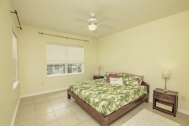 tiled bedroom featuring ceiling fan