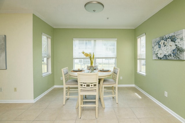 tiled dining room featuring ornamental molding