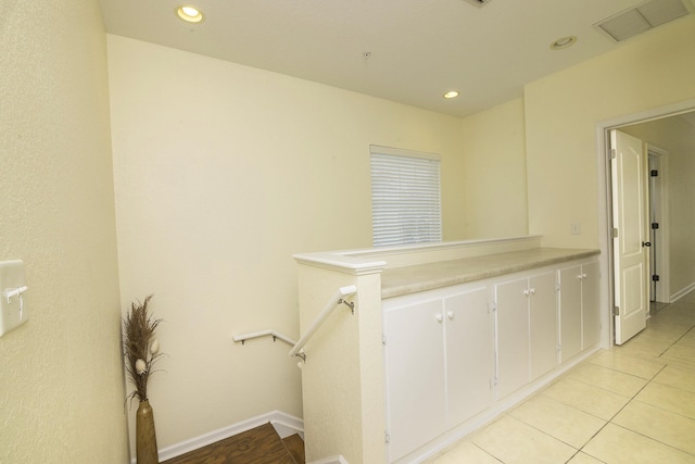 hall featuring light tile patterned floors