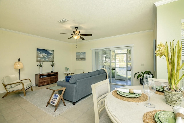 tiled living room with ornamental molding, a textured ceiling, and ceiling fan