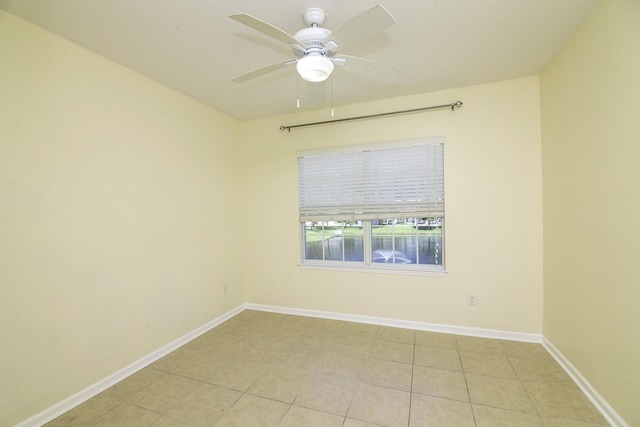 tiled empty room with ceiling fan