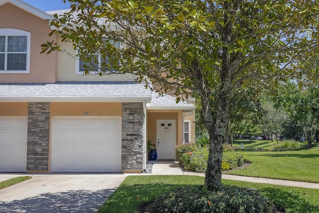 view of front of property featuring a garage and a front lawn