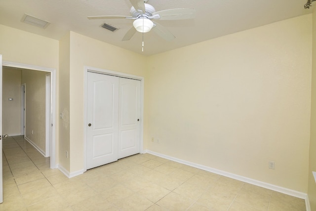 unfurnished bedroom featuring a closet and ceiling fan