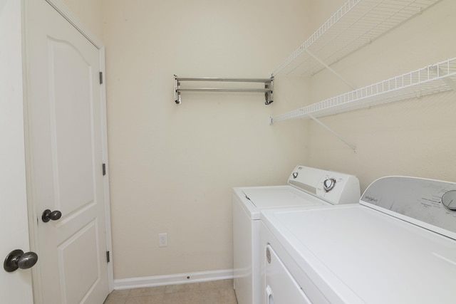 clothes washing area featuring separate washer and dryer