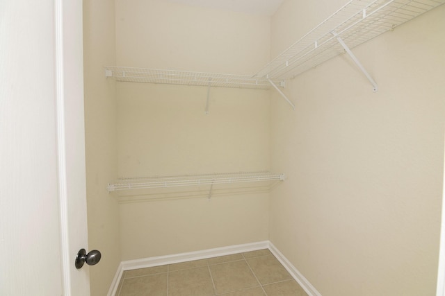 walk in closet with tile patterned floors