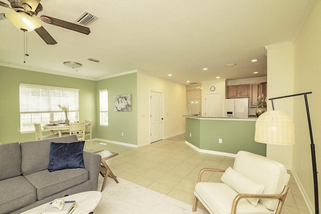 living room with light tile patterned floors, ornamental molding, and ceiling fan