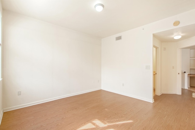 unfurnished room with light wood-type flooring