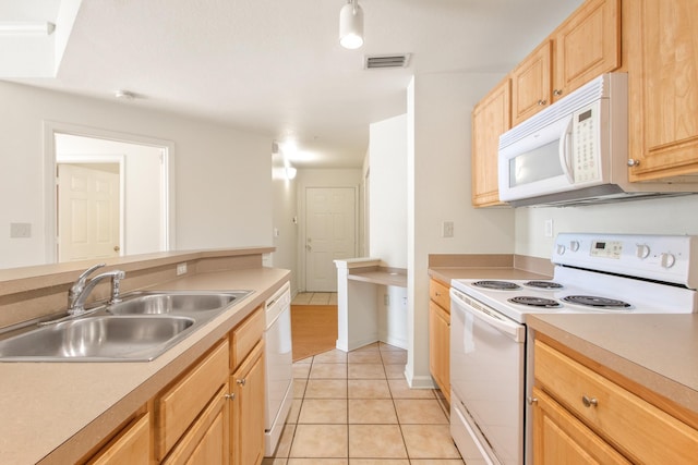 kitchen featuring light brown cabinetry, light tile patterned flooring, sink, and white appliances