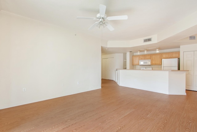 unfurnished living room featuring ceiling fan and light hardwood / wood-style floors