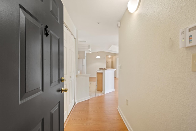 corridor with light hardwood / wood-style flooring