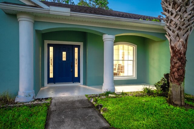 view of exterior entry with covered porch