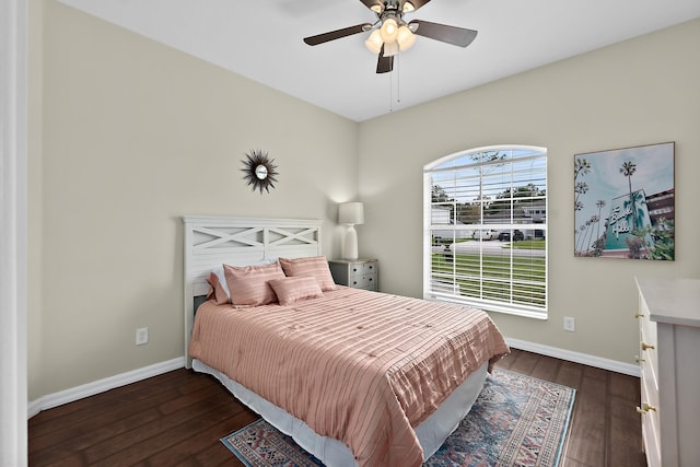 bedroom with dark hardwood / wood-style flooring and ceiling fan