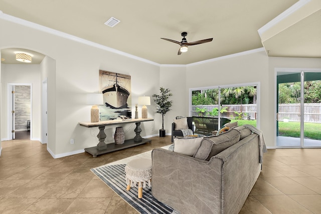 living room featuring ornamental molding, light tile patterned floors, ceiling fan, and a healthy amount of sunlight