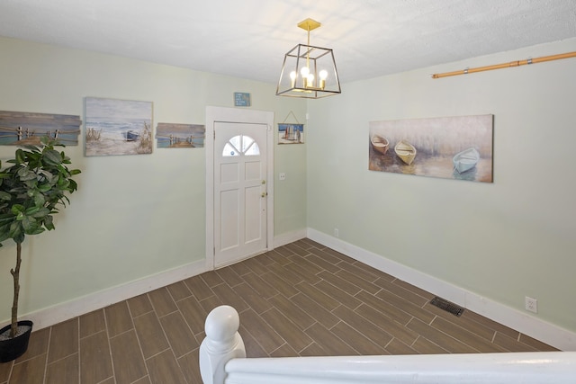 entrance foyer featuring an inviting chandelier