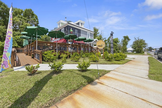 exterior space featuring a deck and a lawn