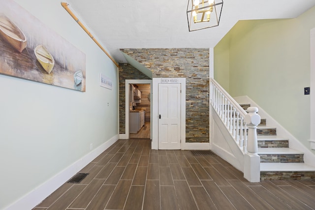 stairs with an inviting chandelier