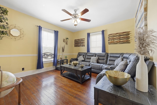 living room with ceiling fan and dark hardwood / wood-style flooring