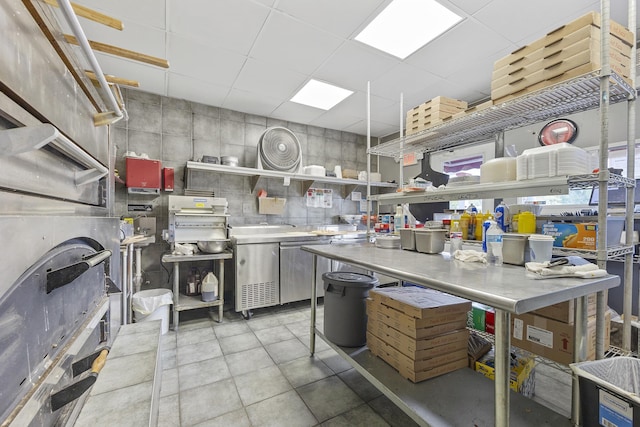 kitchen featuring a paneled ceiling and stainless steel counters