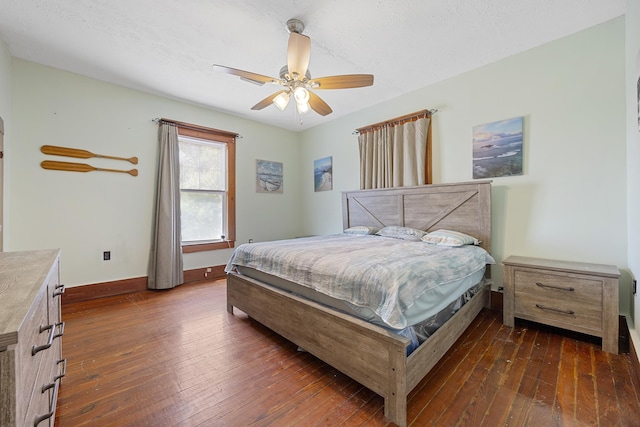 bedroom with a textured ceiling, dark hardwood / wood-style floors, and ceiling fan