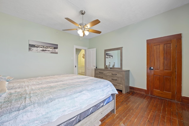 bedroom with ceiling fan and dark hardwood / wood-style flooring