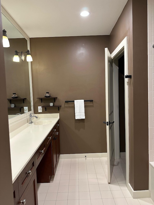 bathroom with tile patterned flooring, recessed lighting, vanity, and baseboards