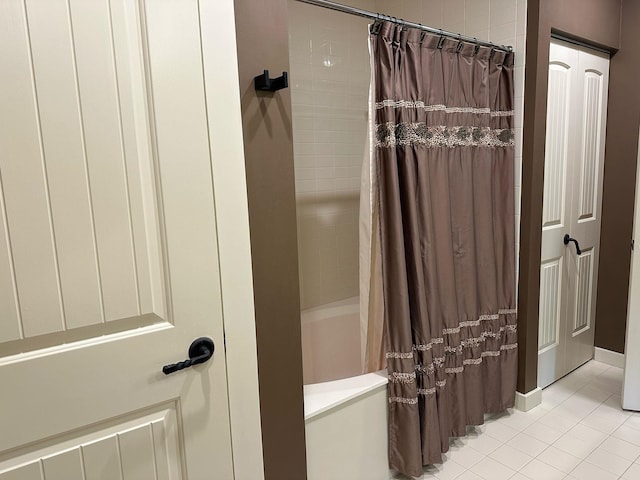 full bath featuring tile patterned flooring and shower / tub combo