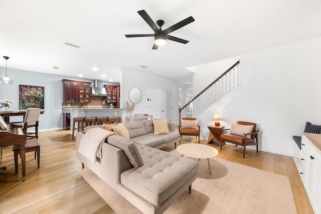 living area featuring light wood finished floors, visible vents, ceiling fan, stairs, and recessed lighting