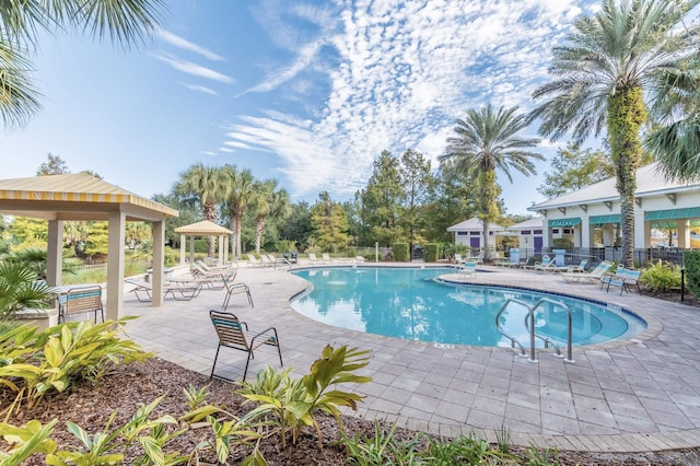 pool featuring fence, a patio, and a gazebo