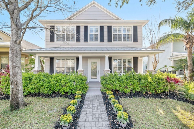 424 High Tide Dr, Saint Augustine, FL 32080 - view of front of house with a standing seam roof, covered porch, and metal roof
