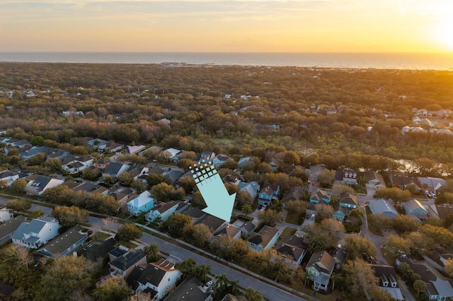 drone / aerial view with a water view and a residential view