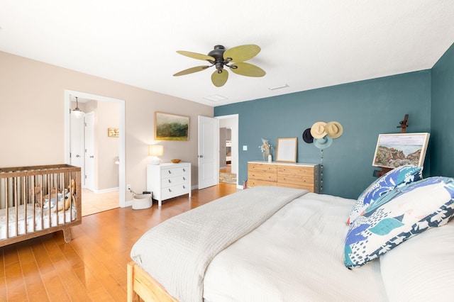 bedroom featuring ceiling fan, baseboards, and wood finished floors