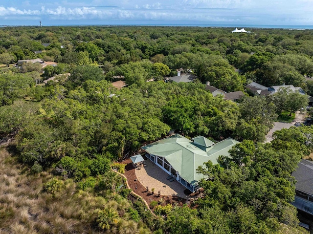 drone / aerial view featuring a wooded view