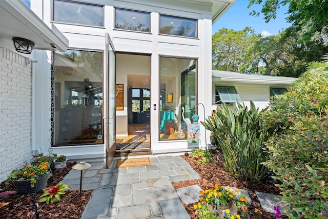 doorway to property featuring brick siding