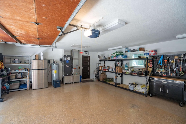 garage with freestanding refrigerator, heating unit, a garage door opener, a workshop area, and electric water heater