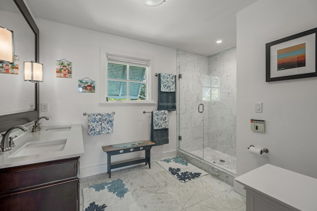 bathroom featuring recessed lighting, baseboards, a shower stall, and a sink