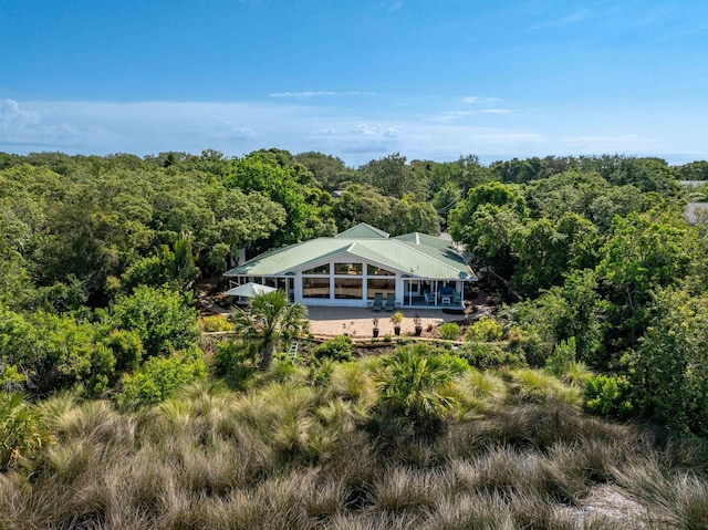 drone / aerial view featuring a wooded view