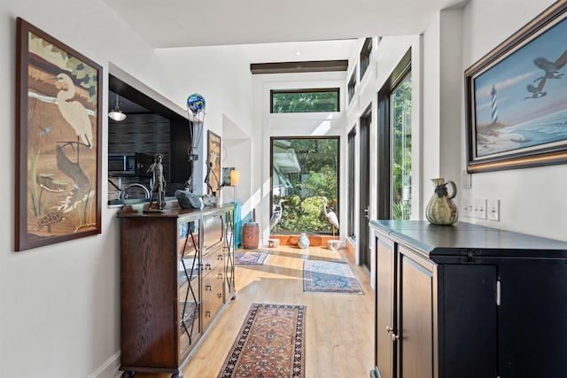foyer entrance featuring baseboards and light wood-type flooring