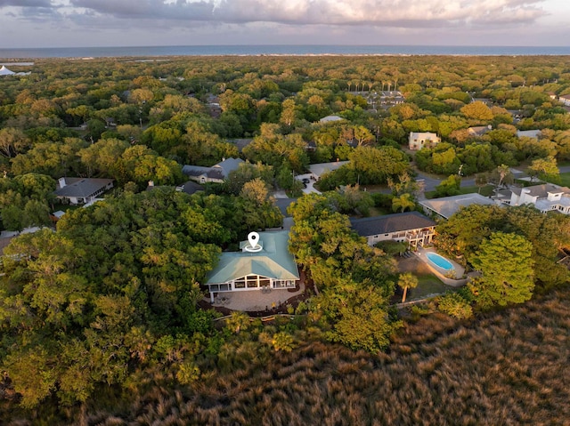 drone / aerial view with a wooded view