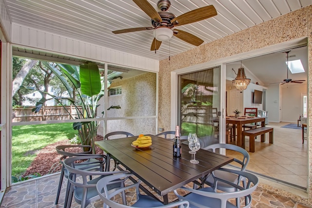 sunroom featuring ceiling fan