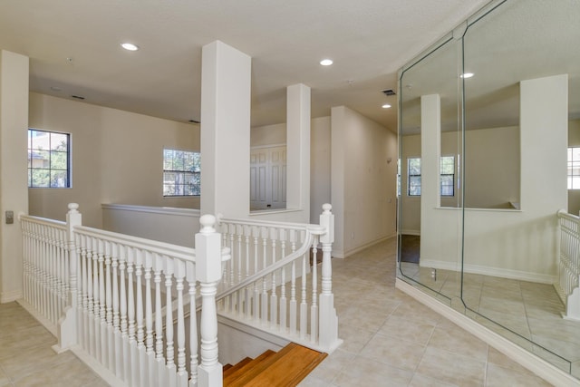 interior space featuring tile patterned floors, recessed lighting, baseboards, and visible vents