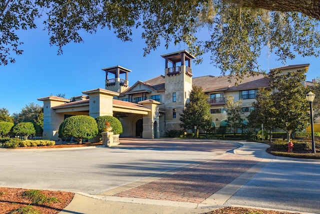 view of building exterior with decorative driveway and a garage